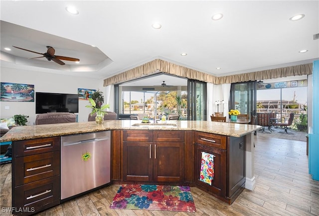 kitchen with dishwasher, ceiling fan, light stone countertops, and light hardwood / wood-style flooring