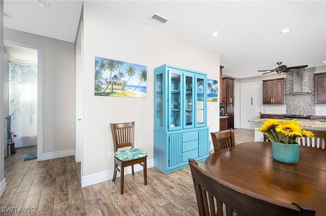 dining room with light hardwood / wood-style flooring and ceiling fan