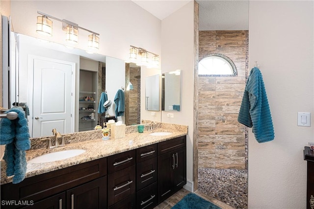 bathroom featuring vanity and a tile shower