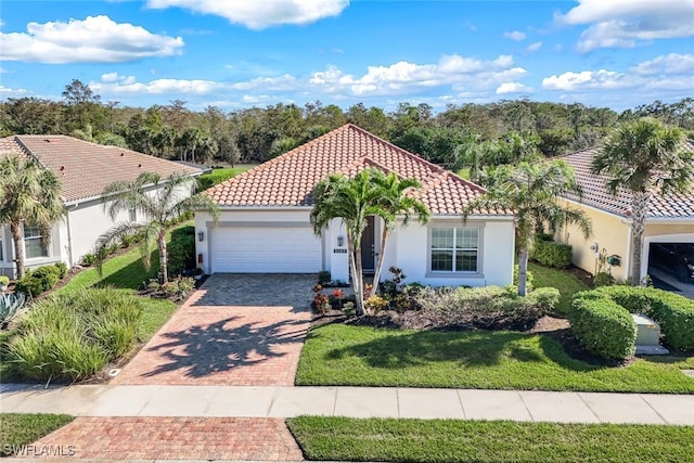 mediterranean / spanish home with a garage and a front yard