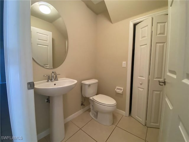 bathroom featuring tile patterned floors, sink, and toilet