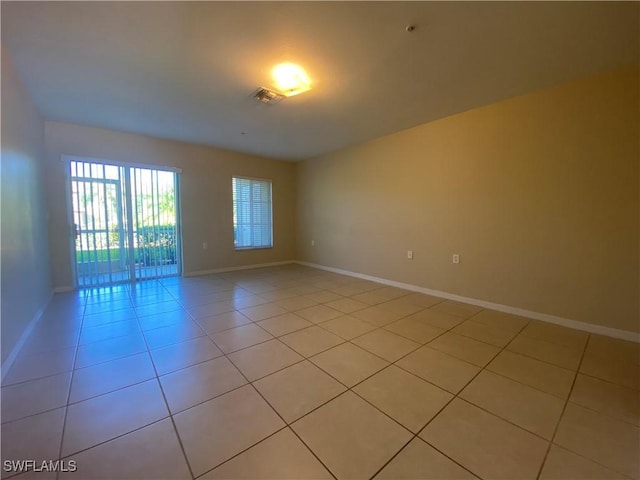 spare room featuring light tile patterned flooring