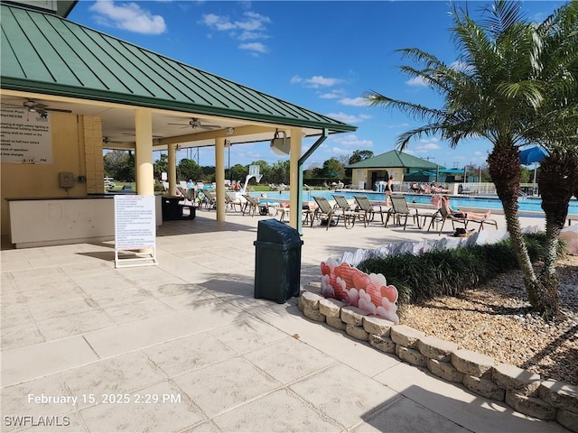 view of patio / terrace with a gazebo, a community pool, and ceiling fan