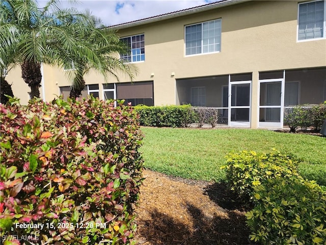 rear view of property with a yard