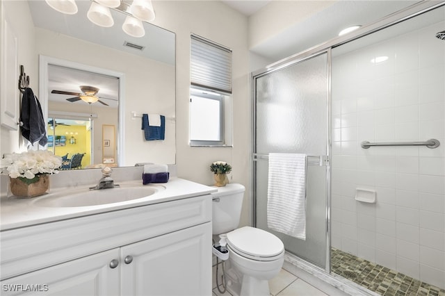 bathroom with tile patterned floors, toilet, a shower with shower door, vanity, and ceiling fan