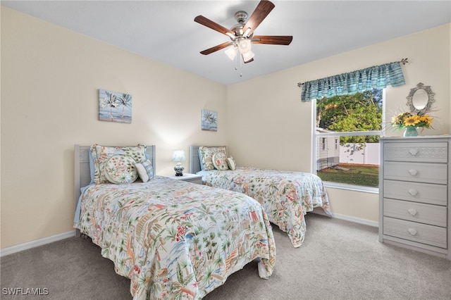 carpeted bedroom with multiple windows and ceiling fan