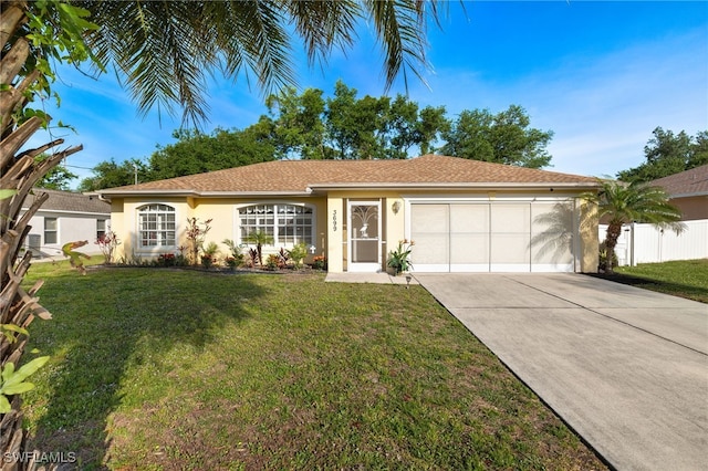 ranch-style home with a garage and a front lawn