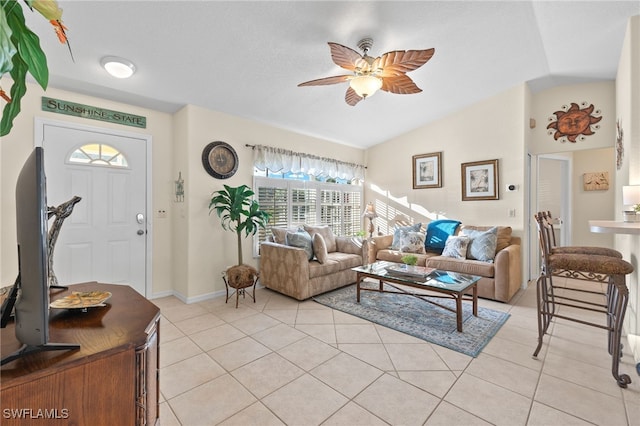 tiled living room featuring ceiling fan and vaulted ceiling