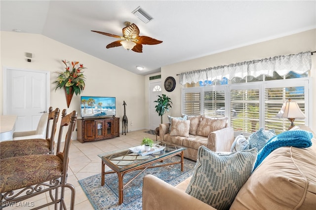 living room featuring ceiling fan, vaulted ceiling, and light tile patterned floors