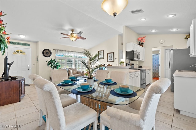 dining area with lofted ceiling, light tile patterned floors, and ceiling fan