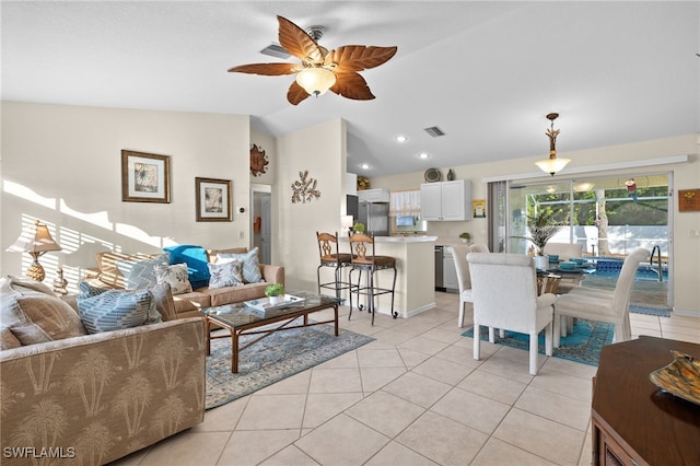 living room featuring ceiling fan, lofted ceiling, and light tile patterned floors