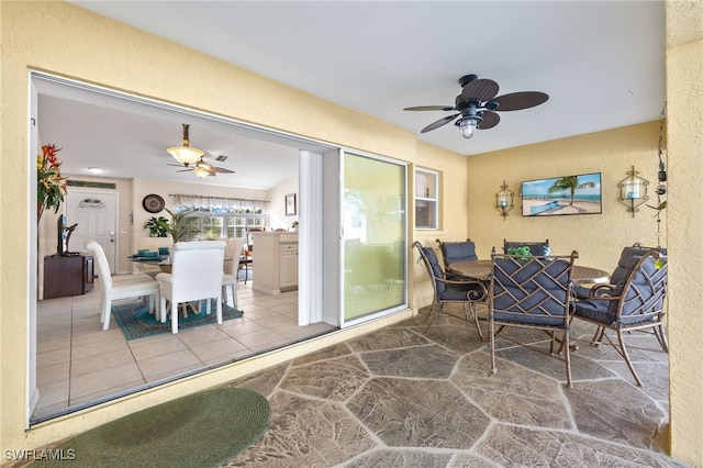 sunroom featuring ceiling fan