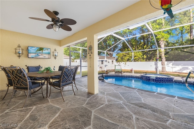 view of swimming pool featuring an in ground hot tub, a storage shed, a lanai, and a patio