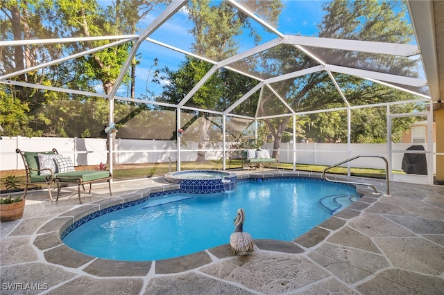 view of swimming pool featuring a patio area, an in ground hot tub, and glass enclosure