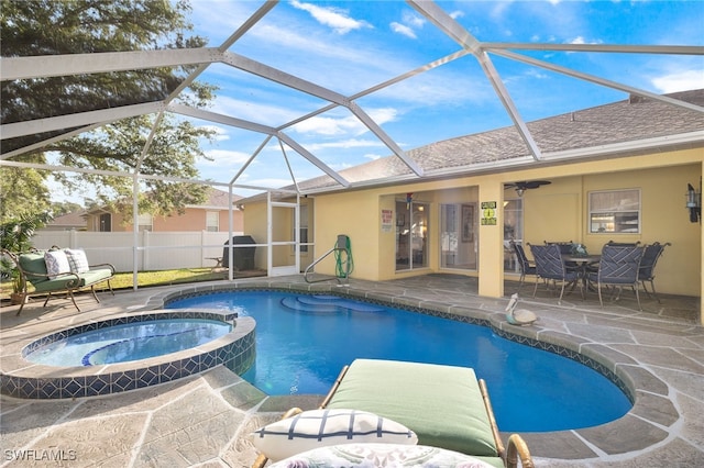 view of swimming pool with an in ground hot tub, ceiling fan, a lanai, and a patio area