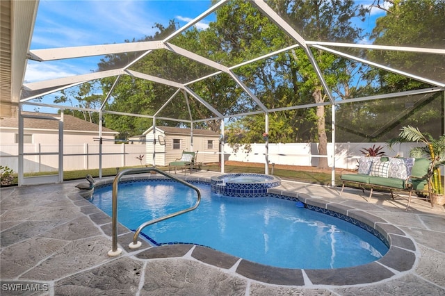 view of pool featuring a lanai, an outbuilding, a patio, and an in ground hot tub