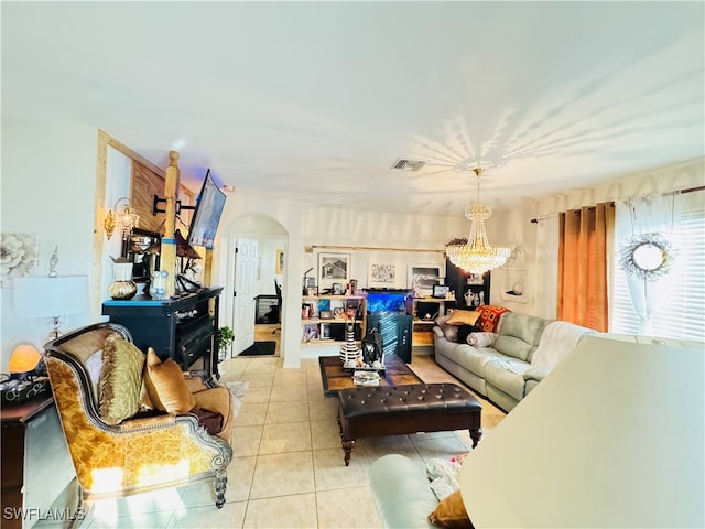 tiled living room featuring a notable chandelier