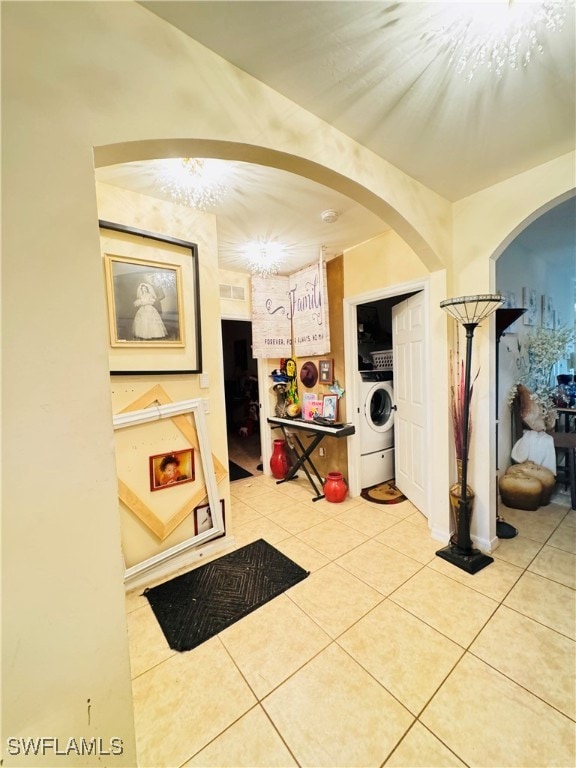 hallway with light tile patterned floors and washer / clothes dryer