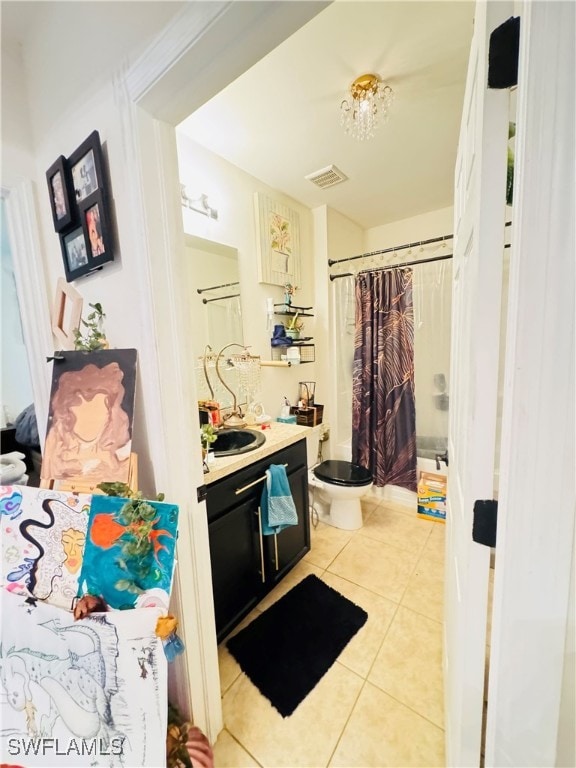 bathroom with tile patterned flooring, vanity, and toilet