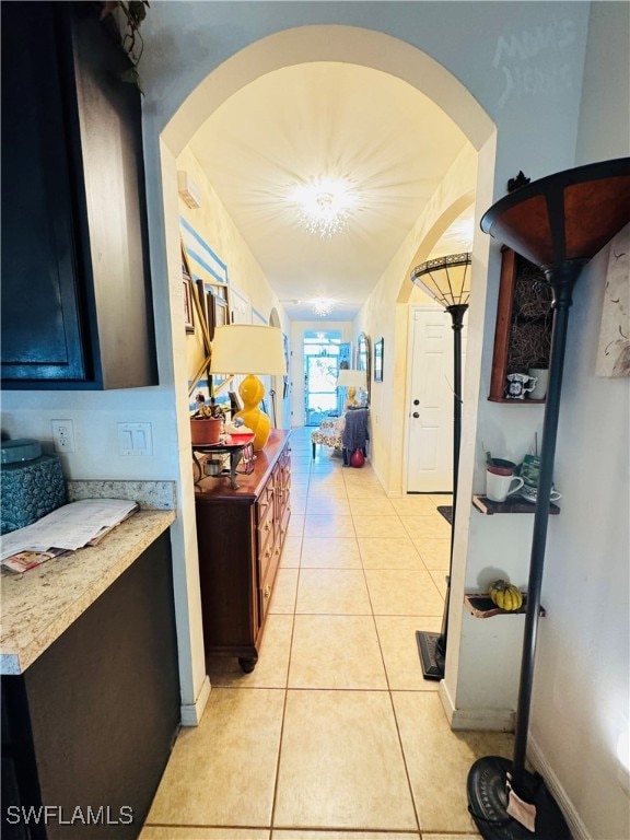 hall with light tile patterned floors