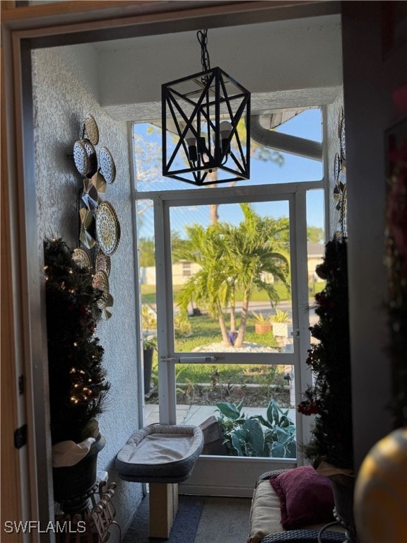 sunroom featuring a chandelier