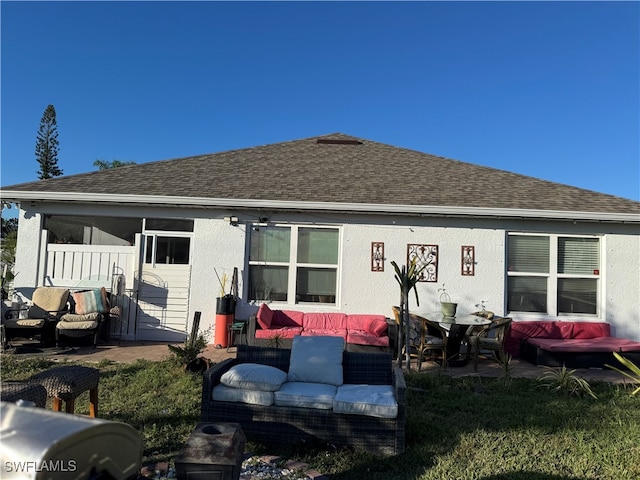 rear view of house with outdoor lounge area and a patio