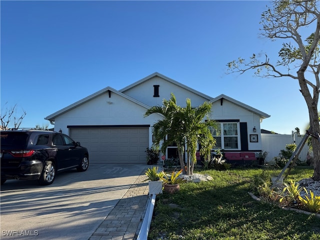 ranch-style house with a front yard and a garage