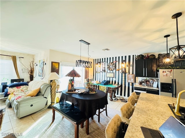 dining space featuring light tile patterned flooring