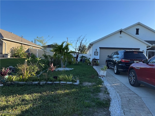 view of side of property featuring a lawn and a garage