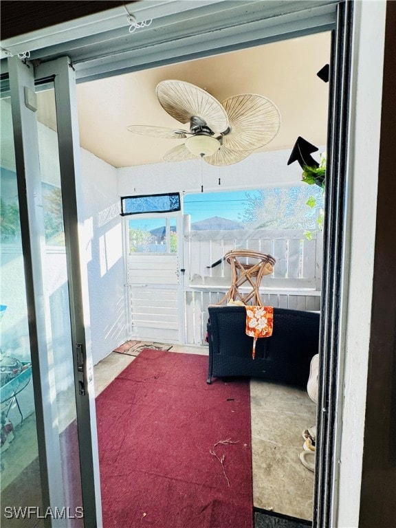 sunroom / solarium featuring ceiling fan