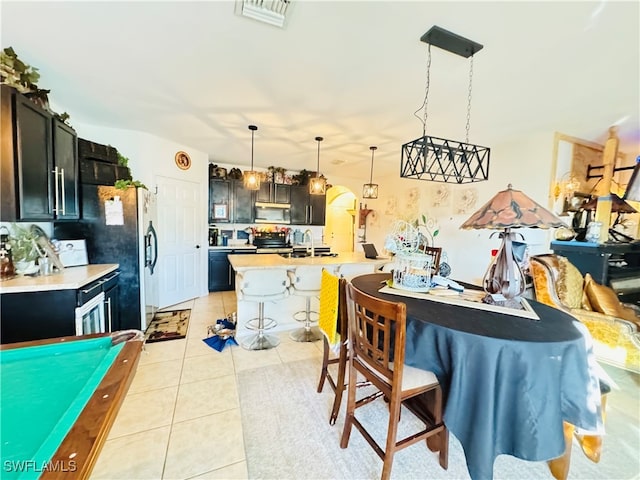 tiled dining room featuring sink and billiards