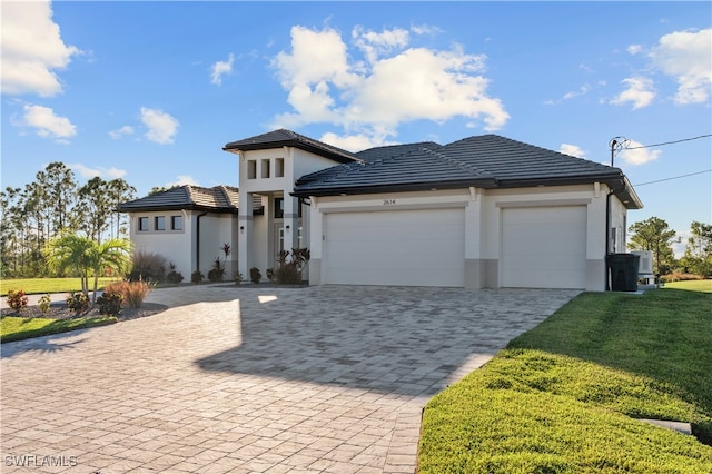 prairie-style home with a garage and a front lawn