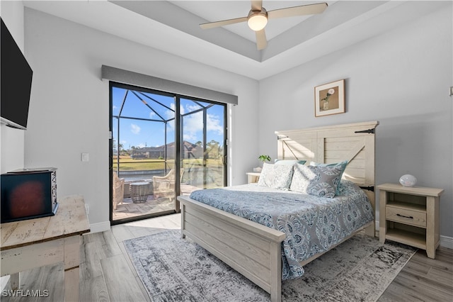 bedroom featuring access to outside, ceiling fan, and light wood-type flooring