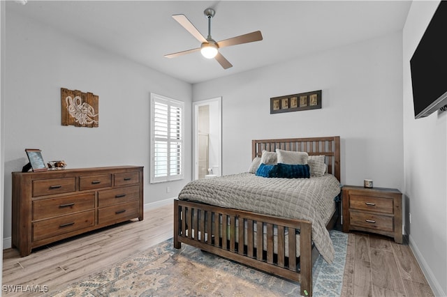 bedroom with ceiling fan, light hardwood / wood-style floors, and ensuite bath