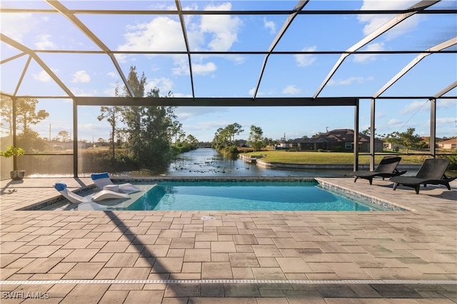 view of swimming pool featuring glass enclosure, a patio area, and a water view