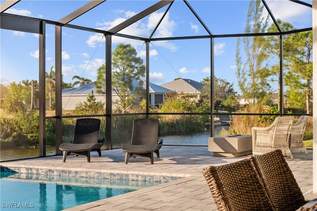 sunroom with a water view and a swimming pool