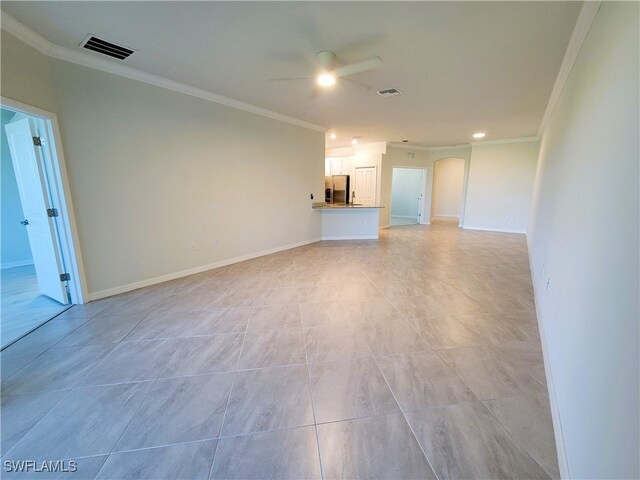 unfurnished living room featuring ceiling fan and crown molding