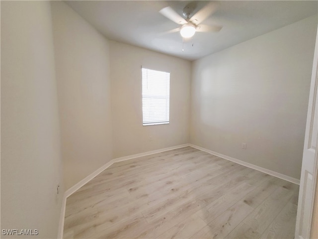 empty room with ceiling fan and light hardwood / wood-style floors