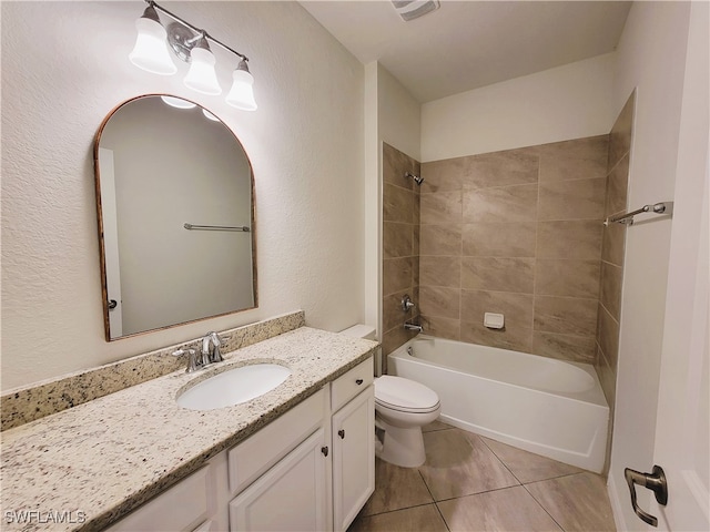 full bathroom featuring tile patterned floors, tiled shower / bath combo, toilet, and vanity