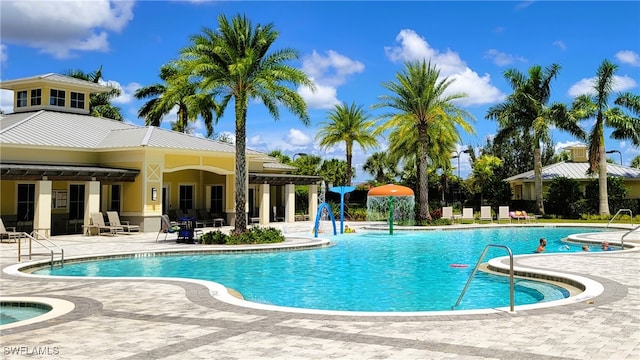 view of pool with a patio area and pool water feature