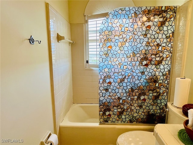 bathroom featuring toilet and shower / bath combination