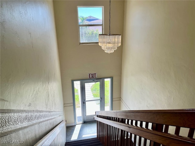 stairway with a chandelier