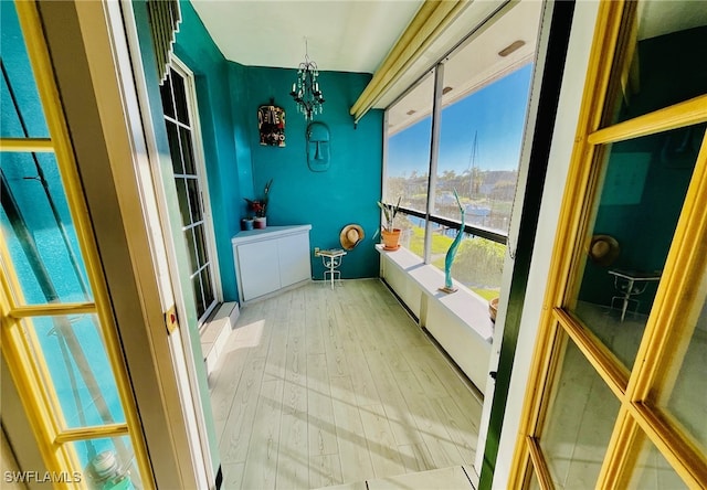 sunroom / solarium with a chandelier