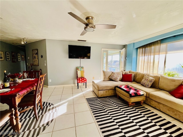 living room featuring ceiling fan and light tile patterned flooring