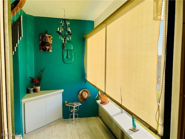 bathroom featuring an inviting chandelier and hardwood / wood-style floors