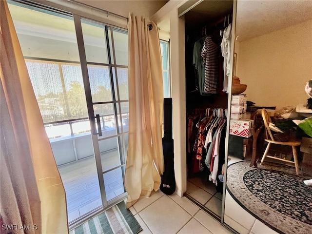 doorway with light tile patterned floors