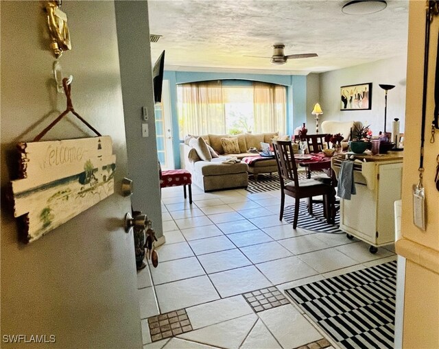 living room featuring ceiling fan and light tile patterned flooring