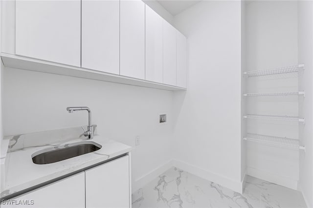 clothes washing area featuring cabinets, sink, and hookup for a washing machine