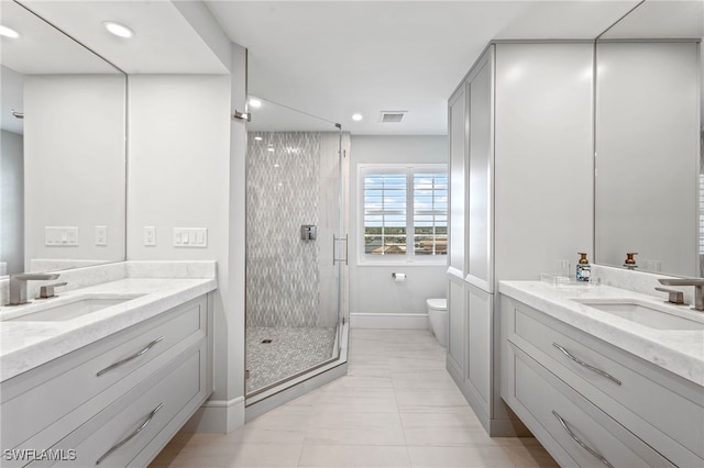 bathroom with tile patterned flooring, toilet, vanity, and walk in shower