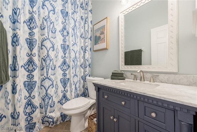 bathroom with tile patterned floors, vanity, curtained shower, and toilet